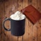 Black coffee cup mockup with whipped cream