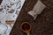 Black coffee grain scattered on the table from a plain bag