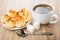 Black coffee, lumpy sugar, spoon and saucer with coconut cookies