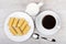 Black coffee, milk jug and rolls wafers in plate