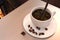 Black coffee pour to coffee cup decorate by coffee beans