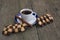 Black coffee in a saucer with a blue border and checkered cookies, a still life