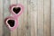 Black coffee in two pink cups heart shape on old wooden floor, Top view, copy space