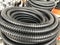Black coiled corrugated insulation tube at warehouse