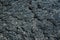 Black cold lava textured background in Lanzarote, Canary Islands Spain