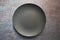 Black color empty ceramic dinner plate isolated