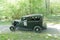 Black color Ford V8 Stock car racer classic car from 1934 driving on a country road