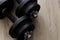 Black color old rusty dumbbells on wood floor surface