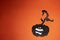 Black colored cut out craft pumpkin with fangs and eyes