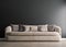 Black concrete mock-up wall with beige velvet sofa and pillows, modern interior, negative copy space above