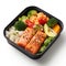 A black container, bento box filled with salmon, broccoli and rice.