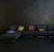 Black couch against dark wall