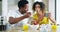 Black couple, breakfast and feeding healthy fruit for diet, meal or eating together at home. African American woman and