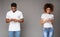 Black couple browsing information at their phones, standing separate