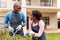 Black couple gardening