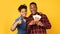 Black Couple Holding Travel Tickets Gesturing Thumbs-Up Standing In Studio