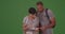 A black couple plan out their hike on green screen