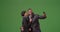 A black couple poses for a picture on green screen