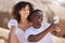 Black couple, smile selfie and beach with a woman and man together for a social media profile picture. Love, photo and