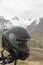 Black Crash helmet in the mountains with snow peak