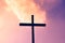 Black cross on a background of red and purple flaming sky, from