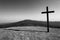 Black cross with mountain in background