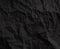 Black crumpled paper texture background