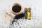 Black cumin seeds in bowl and essential oil in glass bottle. Nigella sativa isolated on white background