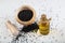 Black cumin seeds in bowl and essential oil in glass bottle. Nigella sativa isolated on white background