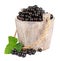 Black currant in a wooden bucket