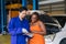 Black customer women multiethnic happy enjoy with asian mechanic worker car service check list in auto center workshop