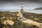 Black cycle at Penmon lighthouse sits at the start of the Menai Strait across from Puffin Island