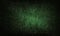 Black dark green grunge background with light spot, particles. Old rough dirty scratched painted wall surface.