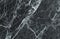 Black and dark marble texture shot through with white deep veining