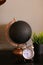 Black decorative stylish globe and clock standing on table near houseplant.