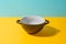 Black deep ceramic bowl on colorful background