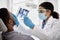 Black Dentist Lady Examining Teeth Of Male Patient With Sterile Dental Tools