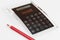 Black design calculator made of acrylic glass with integrated keyboard and red pen