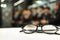 Black Dirty Eyeglasses with blurred classroom in background