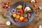 A black dish with barbecue meat. Still-life on a wooden background.