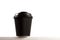 Black disposable coffee cup with copy space.