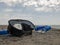 Black diving mask and snorkel on a concrete pier against the background of blue sky and clouds