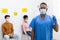 Black Doctor In Face Mask Holding Syringe Standing In Hospital