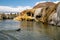 Black dog swims in Hot Springs State Park in Thermopolis Wyoming to retrieve a stick