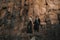 Black dressed wedding couple in rock. In love concept. Newly weds happy couple celebrating love.