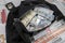 Black duffel bag full of dollar notes in criminal investigation unit