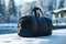 A black duffle bag is sitting on a snowy surface. Generative AI