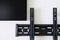 Black durable metal wall mounting bracket for TV and monitor screen on a white background. The concept of mounting a modern TV or