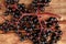 Black elderberries Sambucus on wooden table, top view