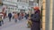 Black elderly Street musical artist male playing on sax for passersby people at town in unfocused